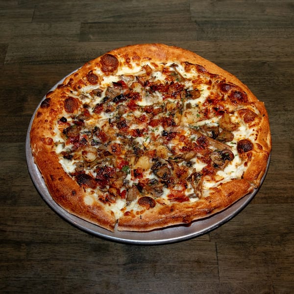 Made from Skratch Pizza Kitchen's mushroom and onion pizza with a golden crust on a metal pan.