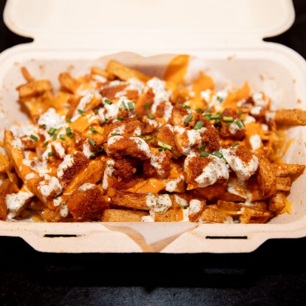 Made from Skratch Pizza Kitchen's loaded fries with cheese sauce, crispy chicken, ranch, and chives.